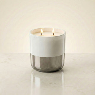 Cascading Moonlight Twilight Reverie luxury candle burning with warm dual flames in white-to-silver ombré glass vessel