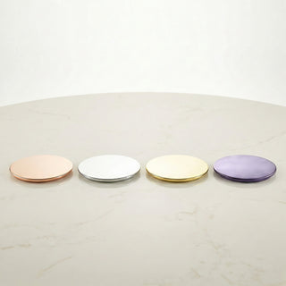 Luxury rose gold, silver, gold, and metallic lilac metal lids for GLORY STRENGTH candle collection on marble surface