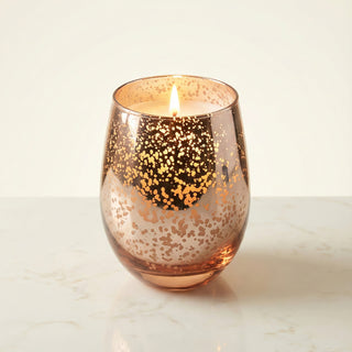 Legacy Collection Yesterday flagship luxury candle lit with warm flame in rose-gold mercury glass vessel