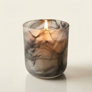 Yin – Shadow Light premium coconut apricot wax candle lit with soft glowing flame, elegant black and gray marbled artisan glass vessel