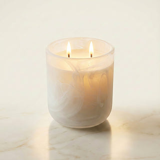 Glory Strength Light Shadow 2-wick luxury candle burning in a white pearl marbled glass vessel on a marble surface, warm candlelight glowing from within, Yin and Yang Collection