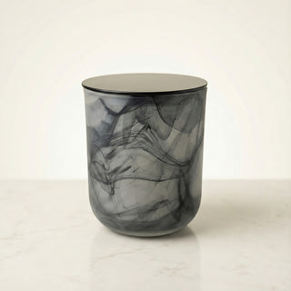 Glory Strength Shadow Light luxury candle in a large black marbled glass vessel with a matte black lid, displayed on a white marble surface